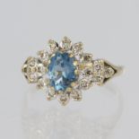 9ct yellow gold fancy cluster ring set with a central oval blue sapphire measuring 8mm x 6mm
