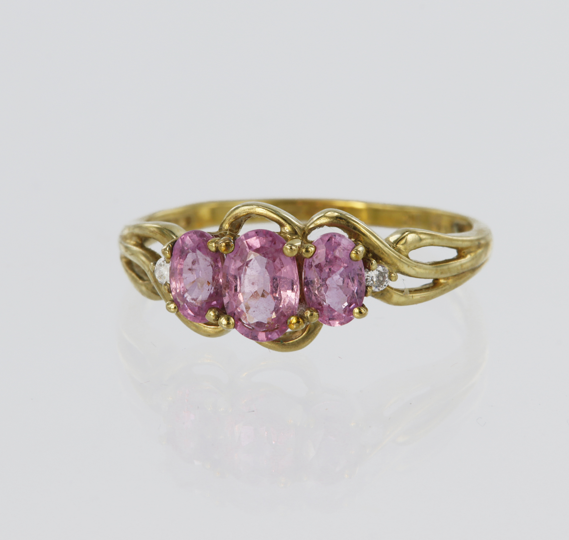 9ct yellow gold ring set with three graduated oval pink sapphires, centre stone measuring approx.
