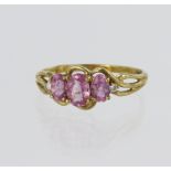 9ct yellow gold ring set with three graduated oval pink sapphires, centre stone measuring approx.