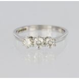 18ct white gold trilogy ring set with three graduated round brilliant cut diamonds, centre diamond