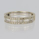 18ct yellow gold diamond set band ring comprising a centre row of twenty one baguette cut diamonds