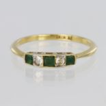 18ct yellow gold ring set with three graduated princess cut emeralds spaced by two round brilliant