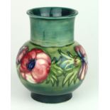 Early Moorcroft. Green Anenome vase. Stamped to base. Height measures approx 13cm.