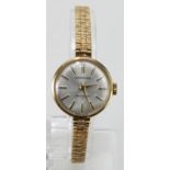 Ladies 9ct cased wristwatch by Garrard on a 9ct bracelet, presentationally engraved on the back,