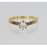 18ct yellow gold solitaire ring set with a single round brilliant cut diamond in an eight claw white