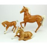 Beswick. Collection of three Palominos ponies. All stamped to base. Lying foal stamped no.915. The