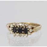 9ct yellow gold triple cluster ring set with three oval sapphires measuring approx. 4mm x 3mm and