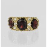 9ct yellow gold dress ring set with three graduated oval garnets, centre stone measuring approx. 8mm