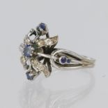 White metal dress ring set with a central oval sapphire measuring approx. 3.5mm x 4mm, with four