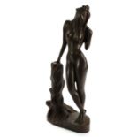 Bronze. A bronze figure, depicting a nude woman leaning on a tree trunk, etched inscription to base,