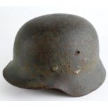 German army 1935 pat steel helmet with liner with its dark green speckled paint finish with a