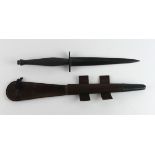 Commando dagger in its brown leather and metal scabbard. Dagger W/D arrow stamped over a 'T'.