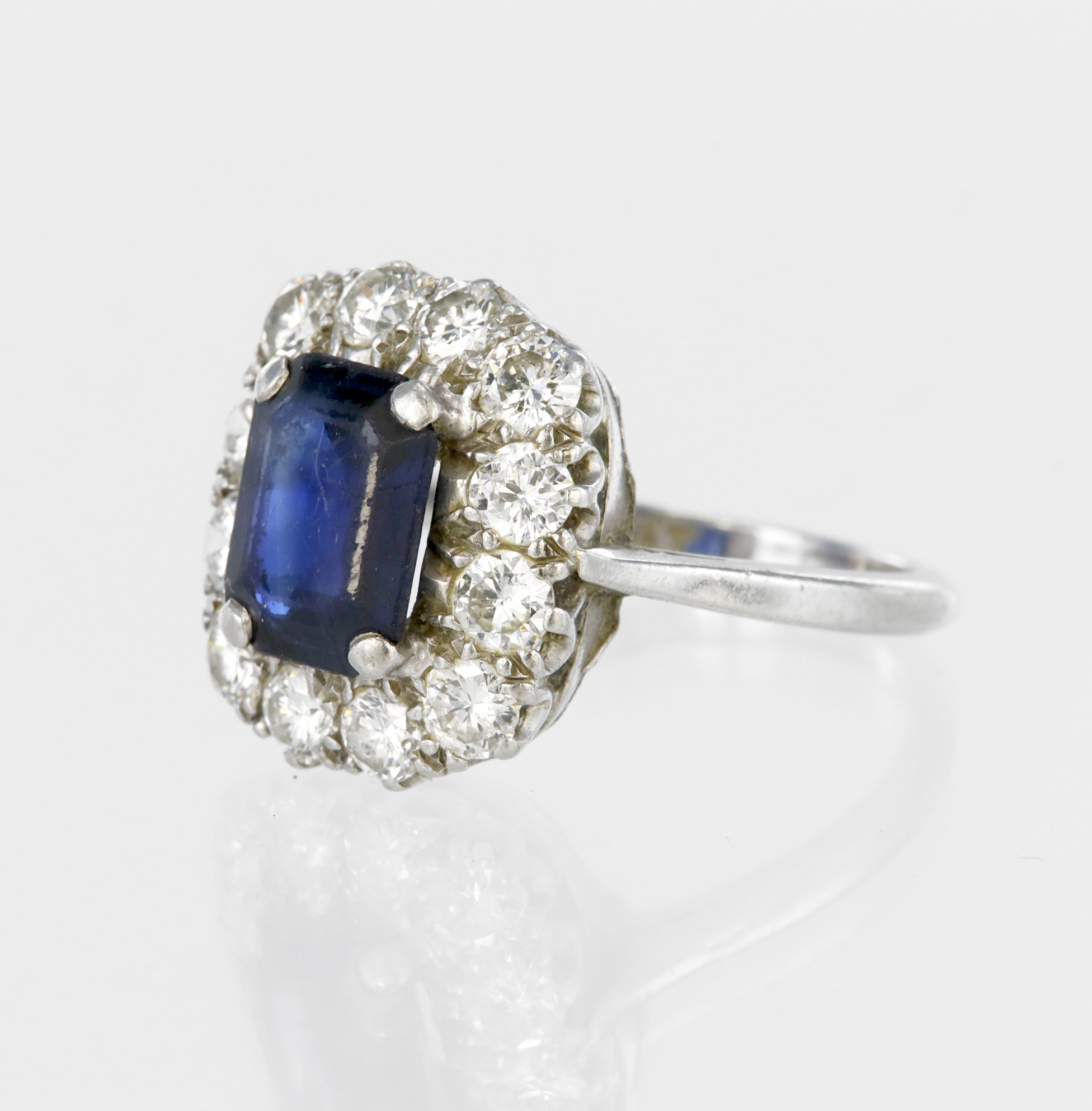 Platinum cluster ring set with a central rectangular step cut sapphire measuring approx. 9mm x - Image 2 of 2