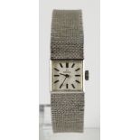 Ladies 9ct white gold cased manual wind Omega wristwatch on a 9ct white gold integral bracelet.