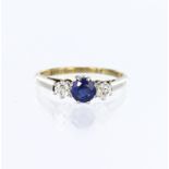 18ct yellow gold and platinum three stone ring featuring a central round sapphire measuring