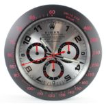 Advertising Wall Clock. Matt black 'Rolex' style advertising wall clock, silver dial reads 'Rolex