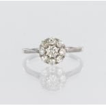 18ct white gold and platinum daisy cluster ring set with nine round brilliant cut diamonds, centre