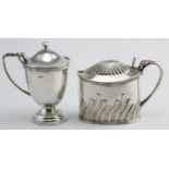 Two silver mustard pots without liners, hallmarked Sheffield 1891 & Birm. 1939. Total weight 5.