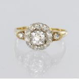 Tests as 18ct yellow gold cluster ring set with a central round old cut diamond weighing approx. 0.