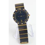 Ladies quartz wristwatch by Corum. The black dial with date aperture at 6 o'clock, black & gold