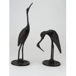 Pair of bronze oriental style cranes measuring approx 18cm & 25.5cm high.