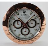 Advertising Wall Clock. Rose gold 'Rolex' style advertising wall clock, white dial reads 'Rolex