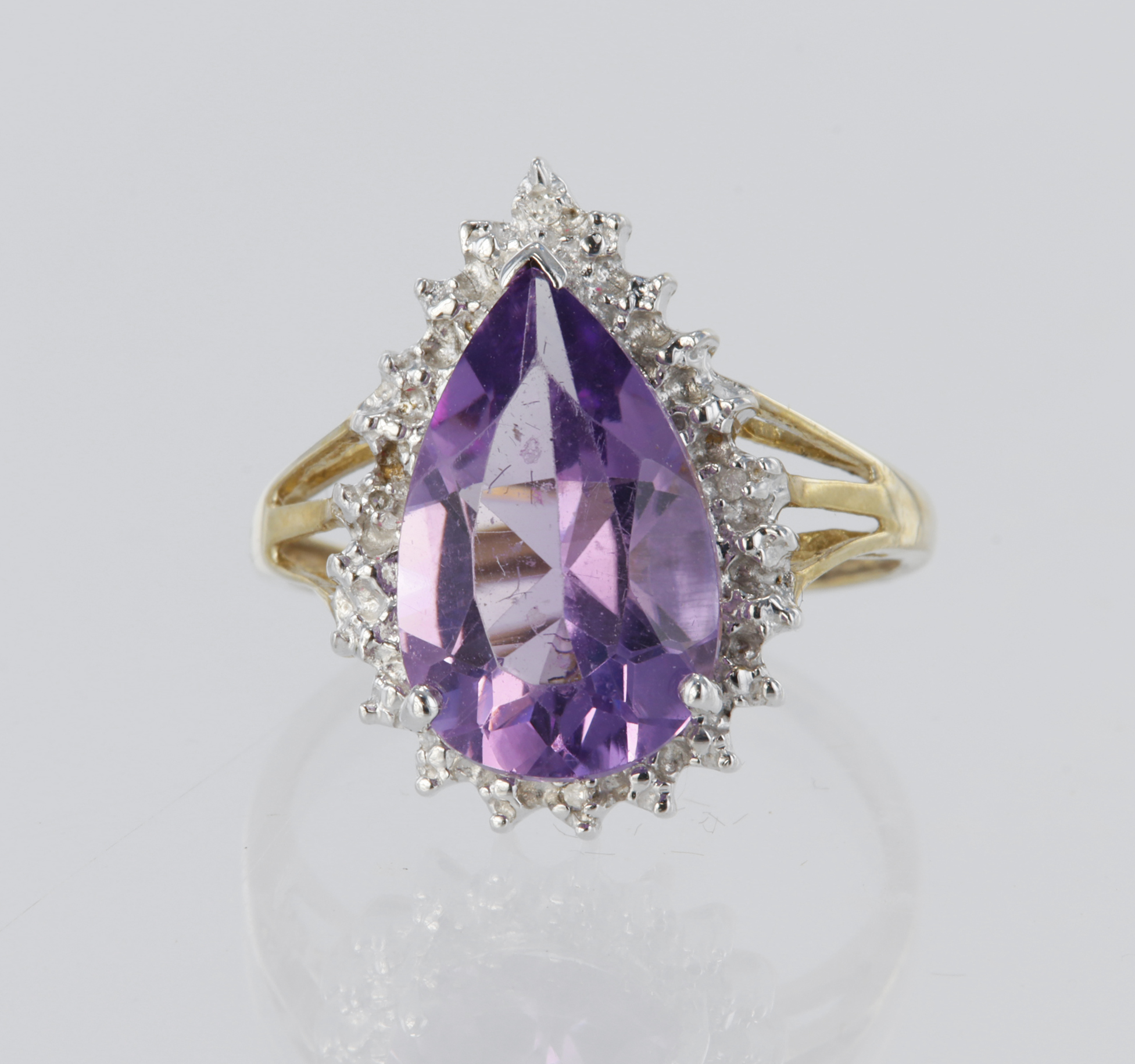 9ct yellow gold cluster dress ring set with a central pear shaped amethyst measuring approx. 14mm