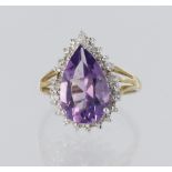9ct yellow gold cluster dress ring set with a central pear shaped amethyst measuring approx. 14mm