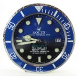 Advertising Wall Clock. Blue 'Rolex' style advertising wall clock, black & blue dial reads 'Rolex