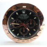 Advertising Wall Clock. Rose gold 'Rolex' style advertising wall clock, black dial reads 'Rolex