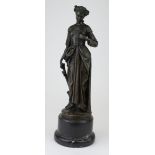 Bronze figure of a woman standing. On a marble base. Signed Zegut/Tusey. Height measures approx 34.