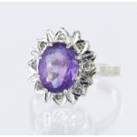 9ct yellow gold cluster dress ring set with a central oval amethyst measuring approx. 10mm x 8mm