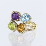 18ct yellow gold dress ring comprising four clusters set with amethyst, blue topaz, peridot and
