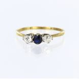 18ct yellow gold and platinum three stone ring set with a central round sapphire measuring approx.