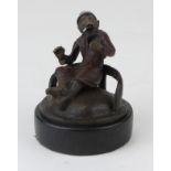 Bronze cold painted figure of a monkey in a silver helmet, wearing a red smoking jacket and