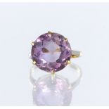 9ct yellow gold ring set with a round amethyst measuring approx. 14mm diameter in an six claw