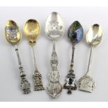 Silver teaspoons. Collection of five souvenir teaspoons comprising four with decorated bowls, one of
