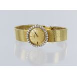 Ladies Omega 18ct wristwatch, with a diamond bezel, on an 18ct Gold bracelet, total weight 43.8g