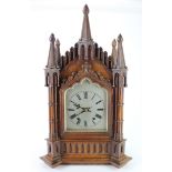 Large Gothic carved oak bracket clock, ornately decorated with columns and spires, dial reads 'G. W.