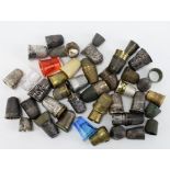 Thimbles. A collection of approximately fifty-five various thimbles, including some silver examples