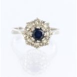 18ct white gold cluster ring set with a central round sapphire measuring approx. 5mm diameter