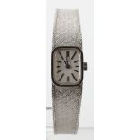 Ladies 9ct white gold manual wind Omega wristwatch on a 9ct integral bracelet (with receipt for £173