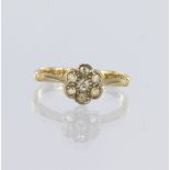 18ct yellow gold daisy cluster ring set with seven round brilliant cut diamonds totalling approx.
