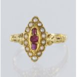 18ct yellow gold marquise shaped ring set with three central rubies surrounded by fourteen seed