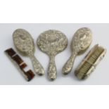 Six piece silver mounted dressing table set in well used condition, comprising four brushes, a