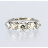Platinum ring set with five graduated round brilliant cut diamonds all in eight claw settings.