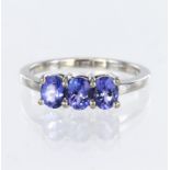14ct white gold ring set with three oval tanzanites totalling 1.16ct (stamped in shank), finger size