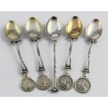 Five silver golf spoons, four with golf scenes, all have British hallmarks. Gross weight 2.25oz