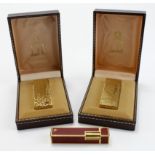 Dunhill. Two gold plated Dunhill lighters, both contained in original cases, together with a red