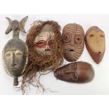 Five African tribal masks, largest 51cm x 18cm approx.